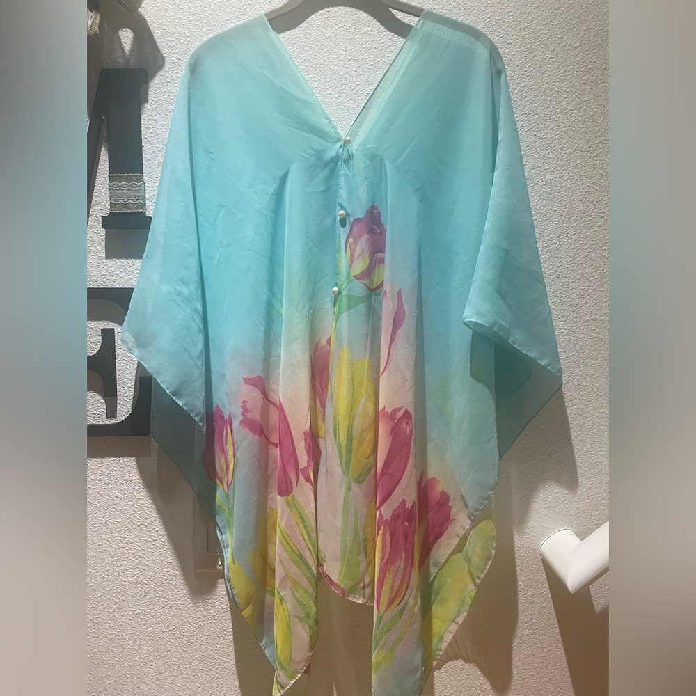 light blue tunic with beautiful flowers v-neck and three pearl buttons